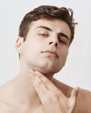 A man touches his chin while gazing