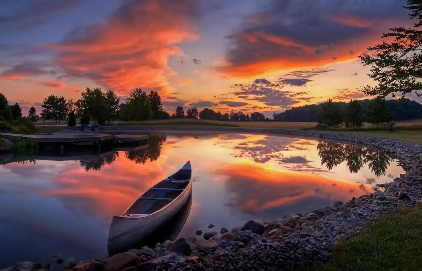 Canoe resting on calm water at sunset