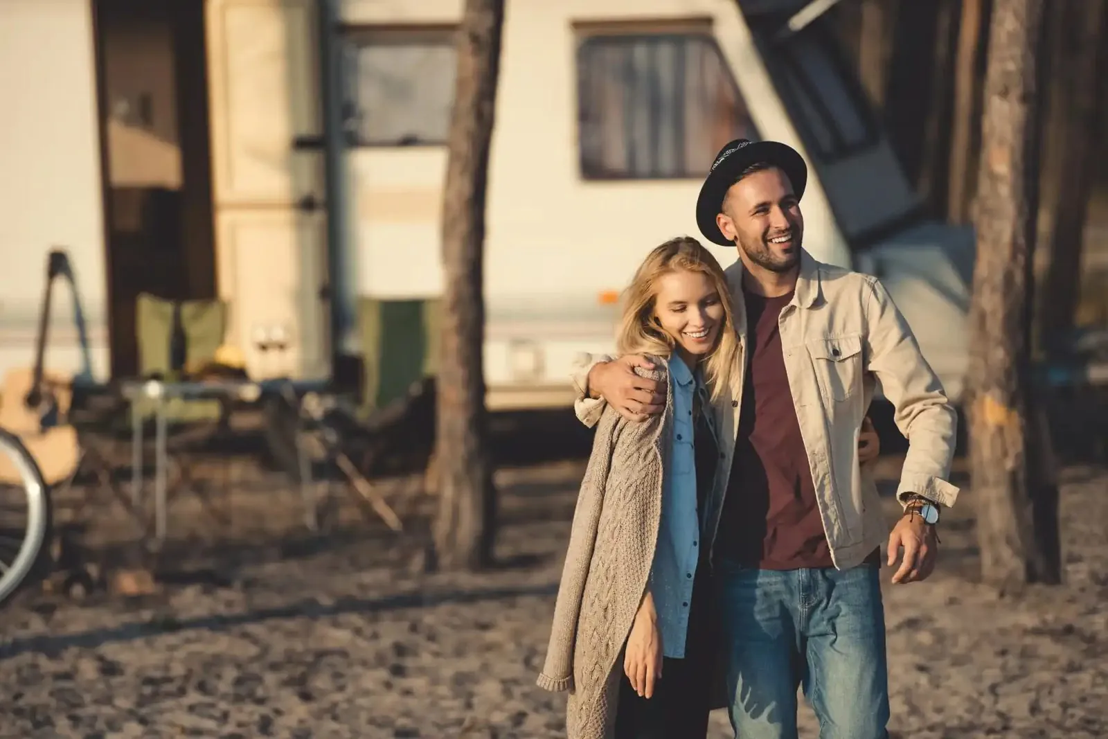 Couple embracing in front of their camper