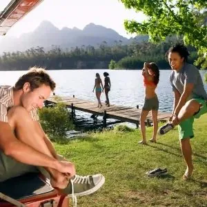 Guests by the swimming lake at the campground